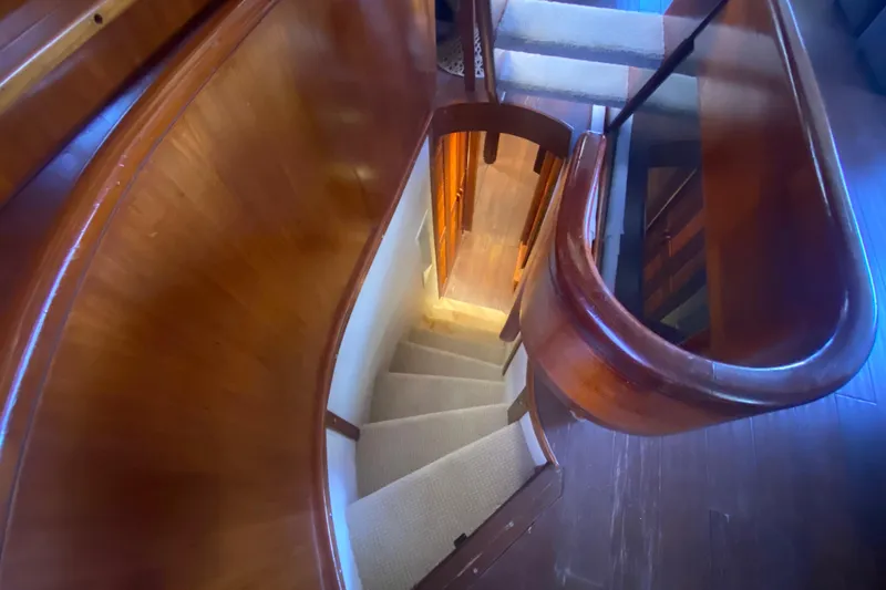 Slide: The Image of Curved wooden staircase inside a 1990 Viking 63 Motor Yacht. - 46