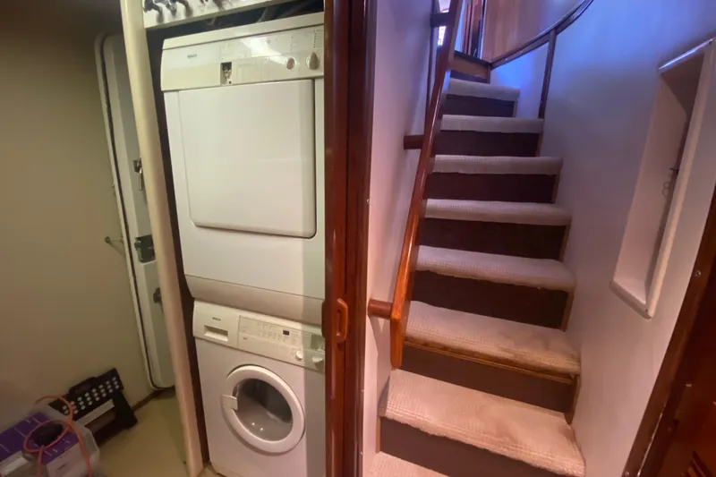 Slide: The Image of Laundry area and staircase inside a 1990 Viking 63 Motor Yacht. - 47