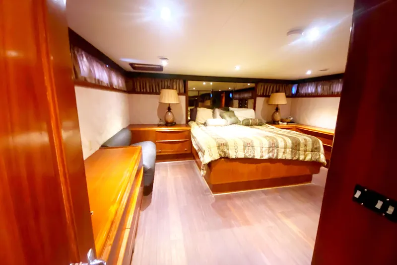 Slide: The Image of Luxurious bedroom interior of 1990 Viking 63 Motor Yacht with elegant wood furnishings. - 49