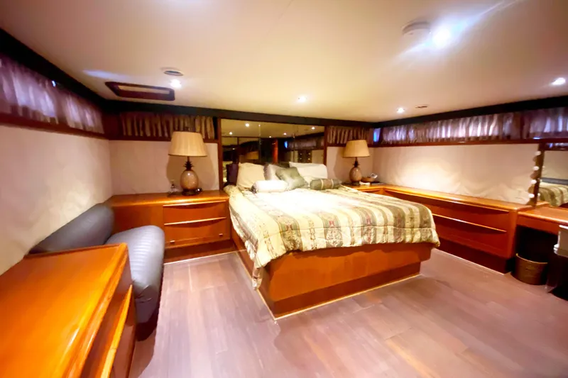 Slide: The Image of Luxurious bedroom interior of 1990 Viking 63 Motor Yacht with elegant wood furnishings. - 50