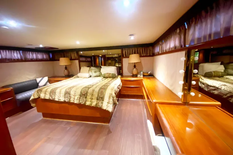Slide: The Image of Luxurious bedroom interior of a 1990 Viking 63 Motor Yacht with elegant wood furnishings. - 51