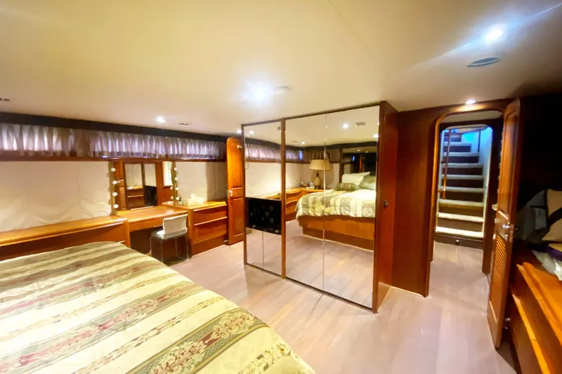 Slide: The Image of Luxurious interior of 1990 Viking 63 Motor Yacht with mirrored closet and elegant furnishings. - 52