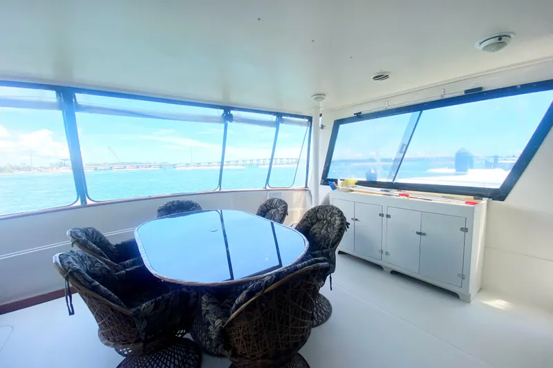 Slide: The Image of Spacious interior of 1990 Viking 63 Motor Yacht with dining area and panoramic windows. - 6