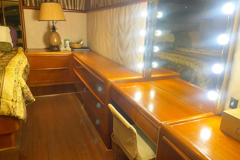 Slide: The Image of Luxurious 1990 Viking 63 Motor Yacht interior with elegant wood vanity and illuminated mirror. - 60