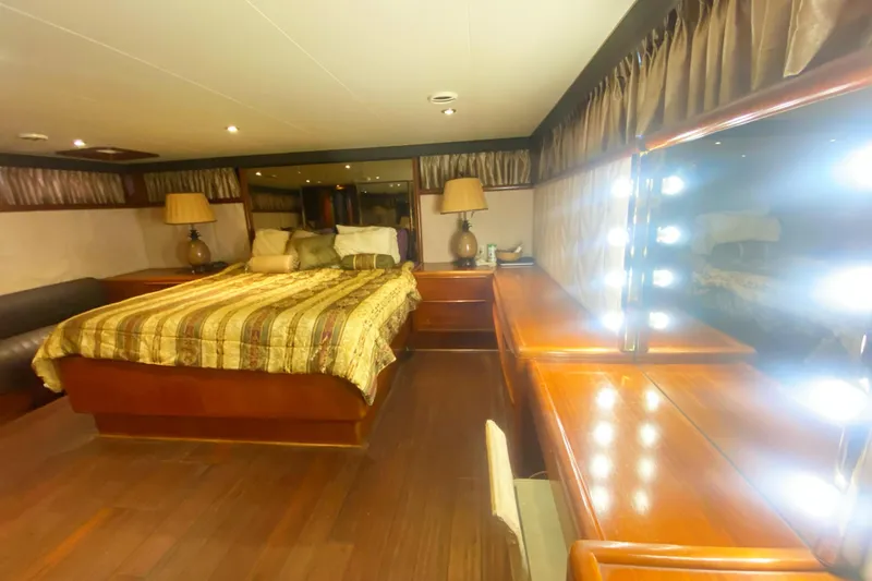 Slide: The Image of Luxurious bedroom interior of 1990 Viking 63 Motor Yacht with elegant wood furnishings. - 61