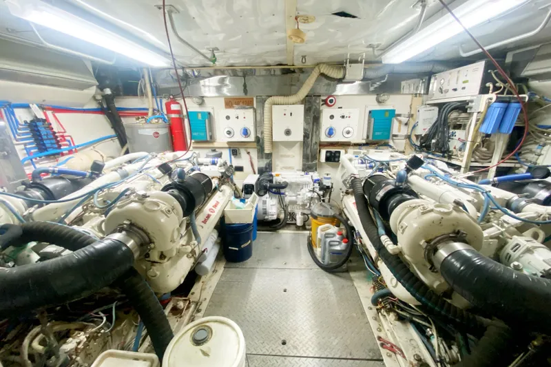 Slide: The Image of Engine room of a 1990 Viking 63 Motor Yacht, showcasing machinery and equipment. - 63
