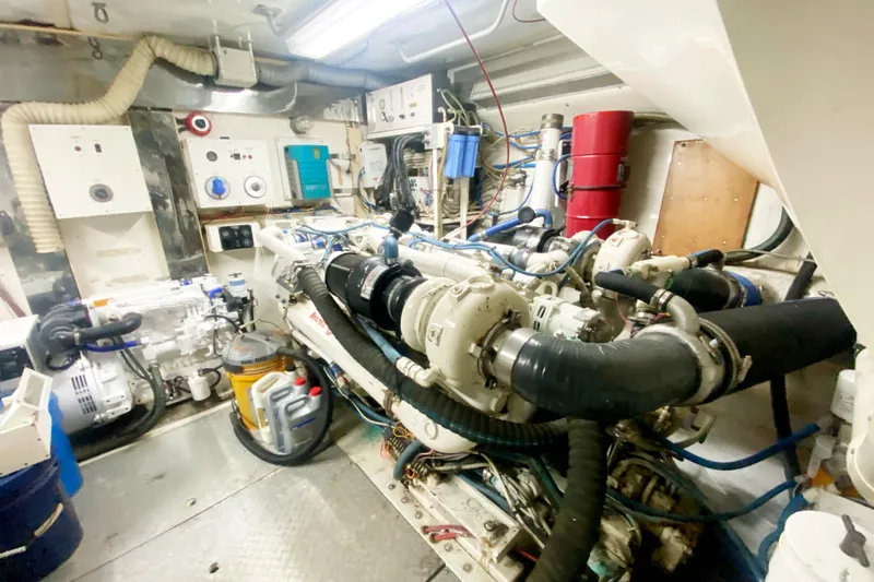 Slide: The Image of Engine room of a 1990 Viking 63 Motor Yacht, showcasing machinery and equipment. - 64