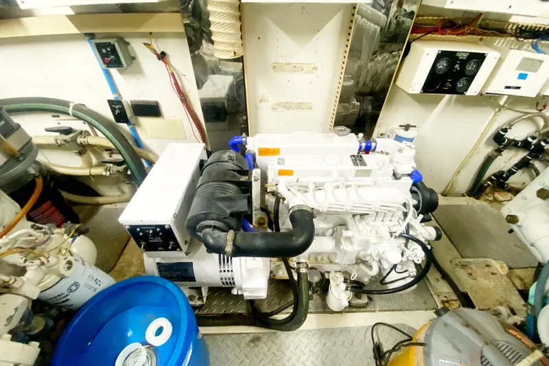 Slide: The Image of Engine room of a 1990 Viking 63 Motor Yacht, showcasing machinery and equipment. - 66