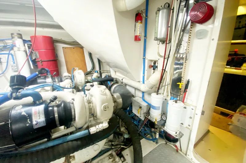 Slide: The Image of Engine room of 1990 Viking 63 Motor Yacht with visible machinery and equipment. - 69