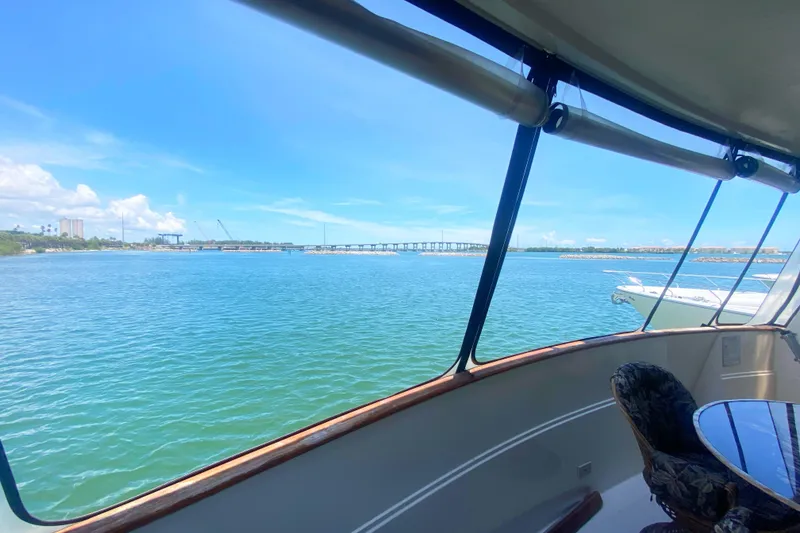 Slide: The Image of View from 1990 Viking 63 Motor Yacht, overlooking serene blue waters and distant bridge. - 7