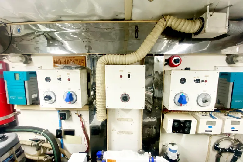 Slide: The Image of Engine room of a 1990 Viking 63 Motor Yacht with control panels and ventilation system. - 70