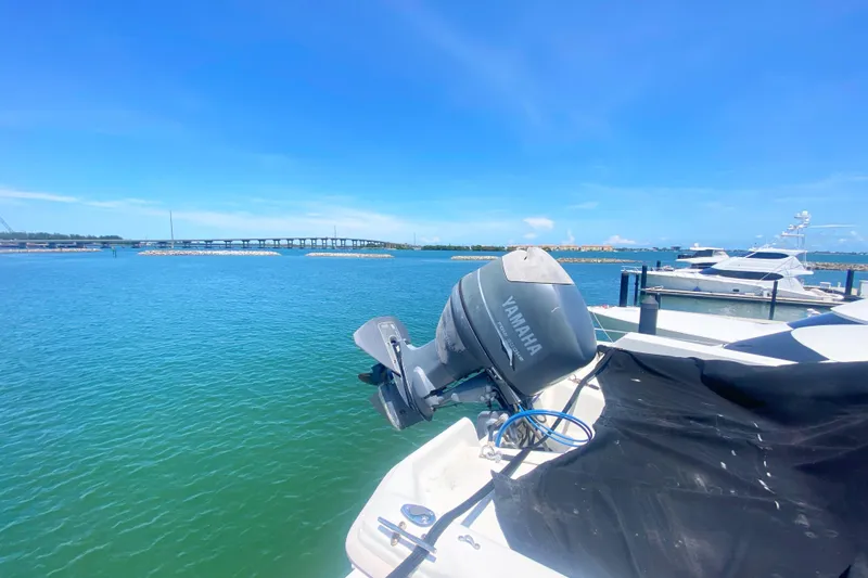 Slide: The Image of 1990 Viking 63 Motor Yacht docked with Yamaha outboard, scenic waterfront view. - 73