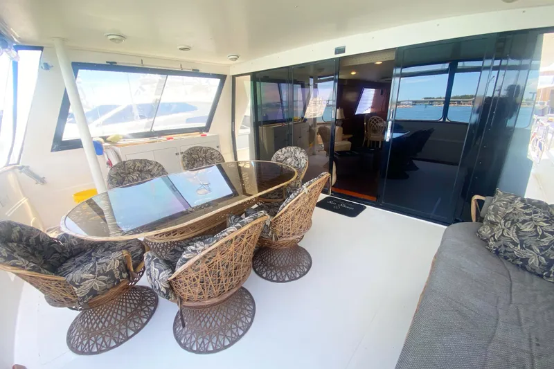 Slide: The Image of Luxurious 1990 Viking 63 Motor Yacht interior with elegant dining area and scenic views. - 8