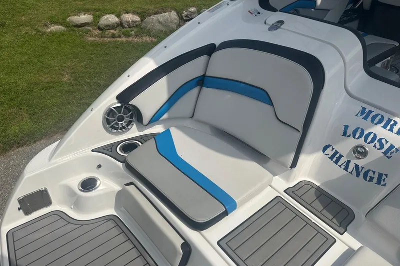 Slide: The Image of 2018 Yamaha 242 X boat interior with seating and speaker, featuring "More Loose Change" text. - 11
