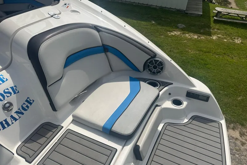 Slide: The Image of 2018 Yamaha 242 X boat interior with cushioned seating and speaker system. - 12