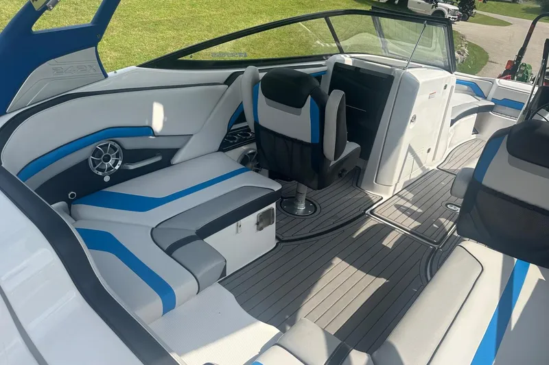 Slide: The Image of 2018 Yamaha 242 X boat interior with blue and white seating, modern design. - 15