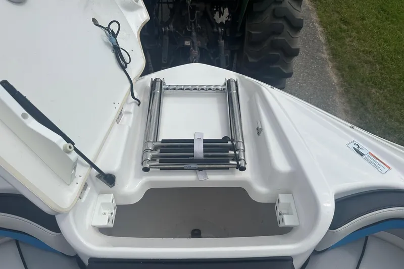 Slide: The Image of 2018 Yamaha 242 X boat with open storage compartment and ladder. - 24