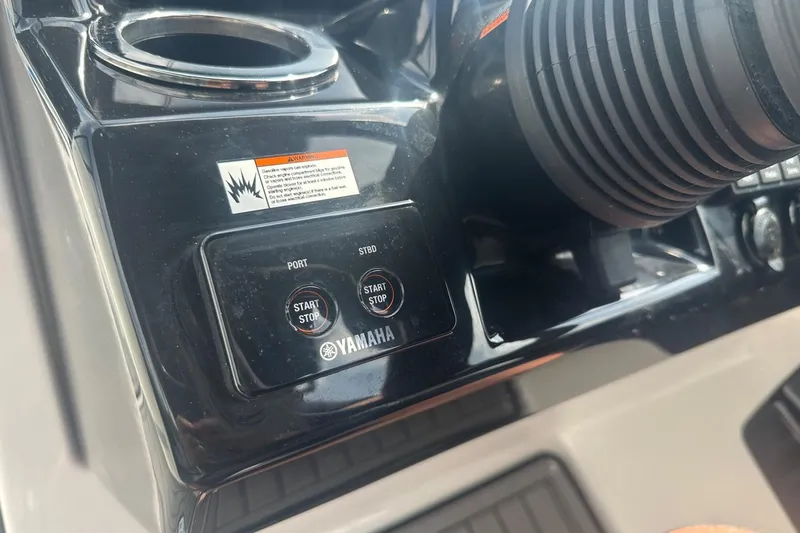 Slide: The Image of Control panel of 2018 Yamaha 242 X boat with start/stop buttons and warning label. - 34