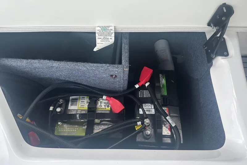 Slide: The Image of Battery compartment of a 2018 Yamaha 242 X boat, featuring wiring and storage space. - 37