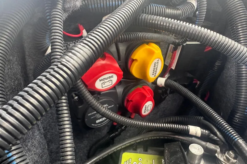 Slide: The Image of Electrical wiring and switches inside a 2018 Yamaha 242 X boat. - 38
