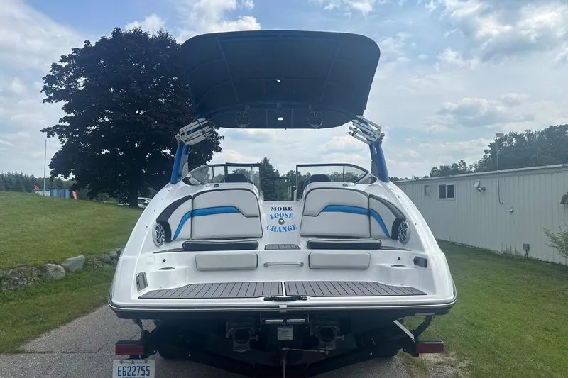Slide: The Image of 2018 Yamaha 242 X boat, rear view, parked outdoors under cloudy sky. - 5