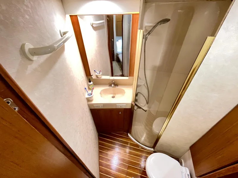 Slide: The Image of Bathroom interior of 2000 Ocean Yachts 43 Super Sport with shower, sink, and toilet. - 16