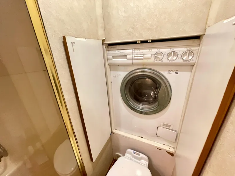 Slide: The Image of Compact laundry area in 2000 Ocean Yachts 43 Super Sport boat. - 17