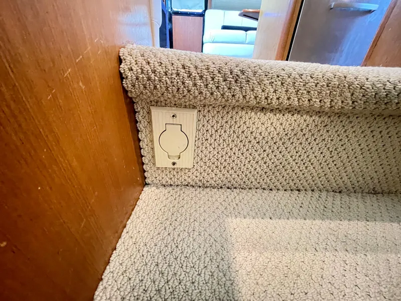 Slide: The Image of Carpeted stairs on 2000 Ocean Yachts 43 Super Sport, featuring a wall outlet. - 18
