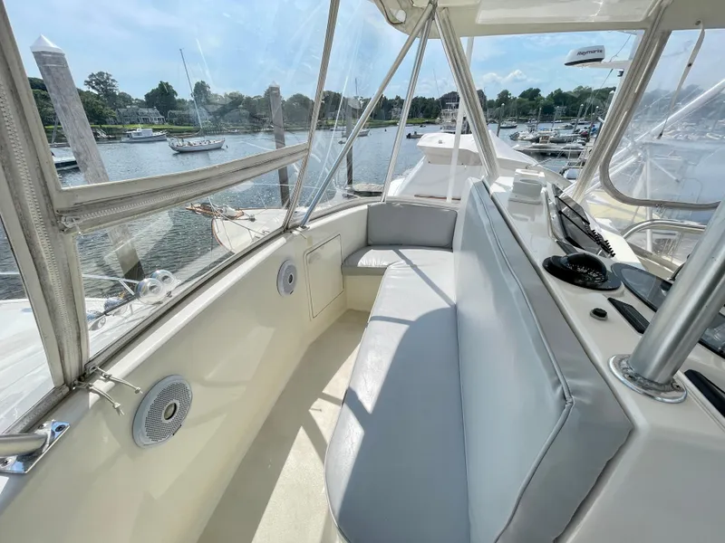 Slide: The Image of 2000 Ocean Yachts 43 Super Sport interior with seating, overlooking marina. - 23