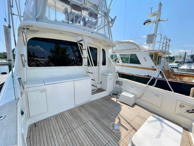 Slide: The Image of 2000 Ocean Yachts 43 Super Sport, spacious deck, marina view, clear sky. - 29