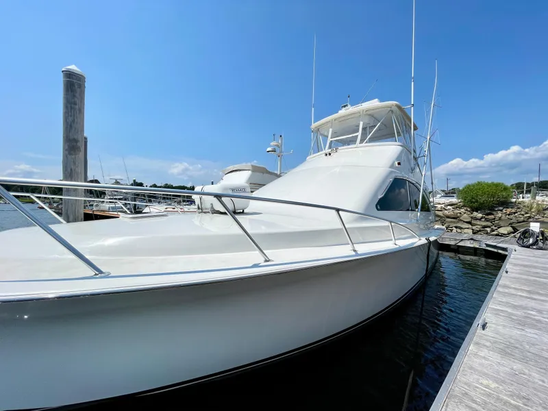 Slide: The Image of 2000 Ocean Yachts 43 Super Sport docked under clear blue sky. - 48