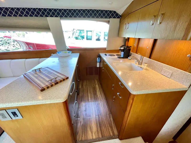 Slide: The Image of Interior of 2000 Ocean Yachts 43 Super Sport, featuring a modern kitchen area. - 6