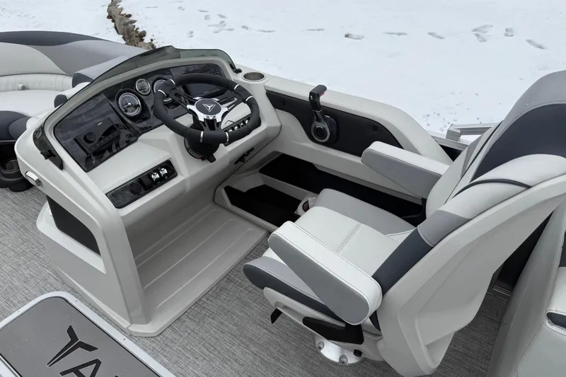 Slide: The Image of 2025 Tahoe 2185 boat cockpit with modern steering and controls, featuring sleek design. - 12