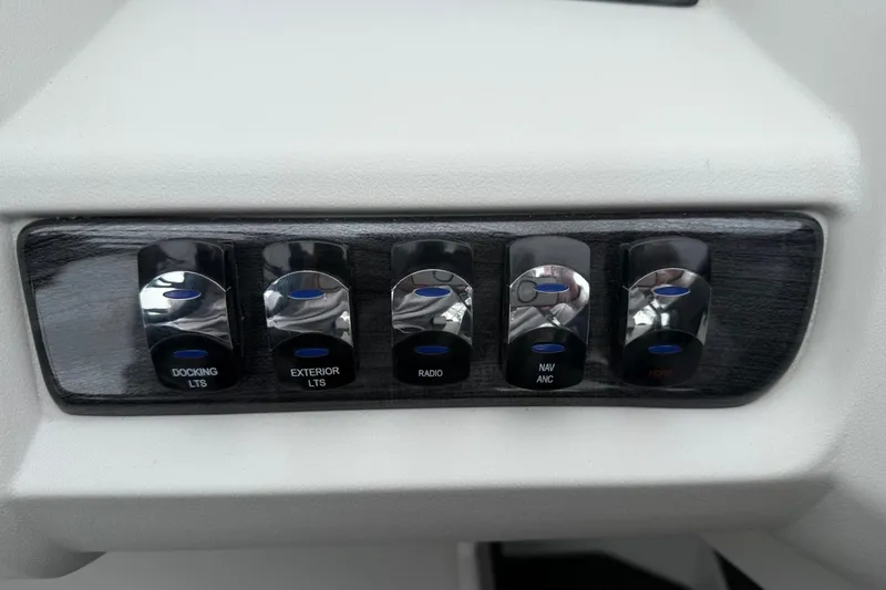 Slide: The Image of Control panel with switches for docking, exterior lights, radio, and navigation on 2025 Tahoe 2185. - 17