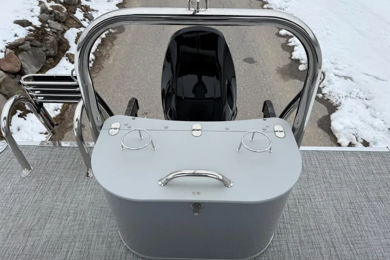 Slide: The Image of 2025 Tahoe 2185 boat stern view with motor and snowy background. - 21