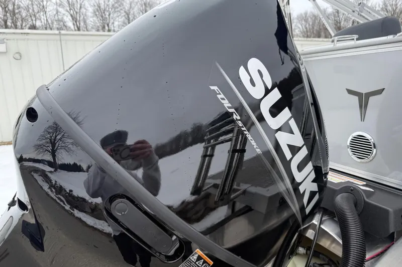 Slide: The Image of ```json { "alt_text": "2025 Tahoe 2185 boat with Suzuki four-stroke engine in snowy setting." } ``` - 22