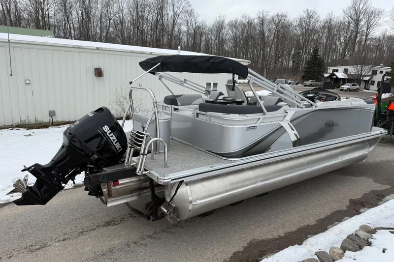 Slide: The Image of 2025 Tahoe 2185 pontoon boat with Suzuki outboard motor on snowy driveway. - 3