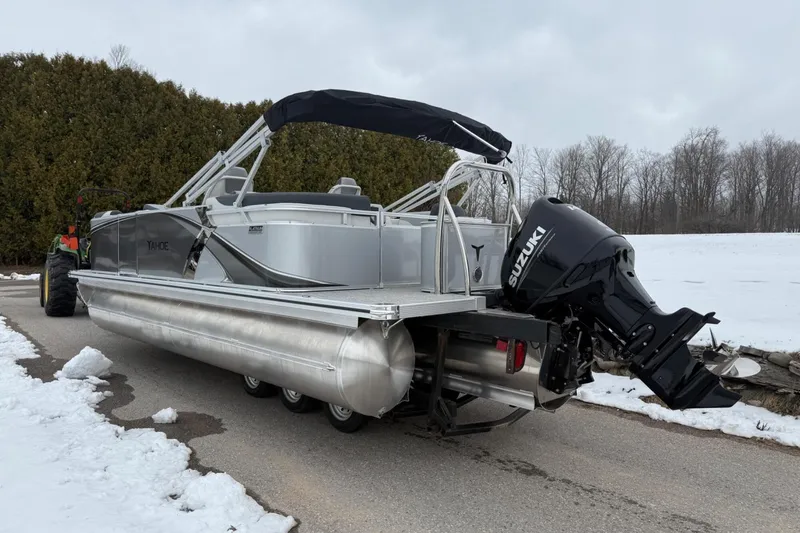 Slide: The Image of 2025 Tahoe 2185 pontoon boat with Suzuki outboard motor on snowy driveway. - 5