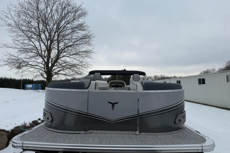 Slide: The Image of 2025 Tahoe 2185 pontoon boat on snowy ground, with overcast sky and bare tree. - 8