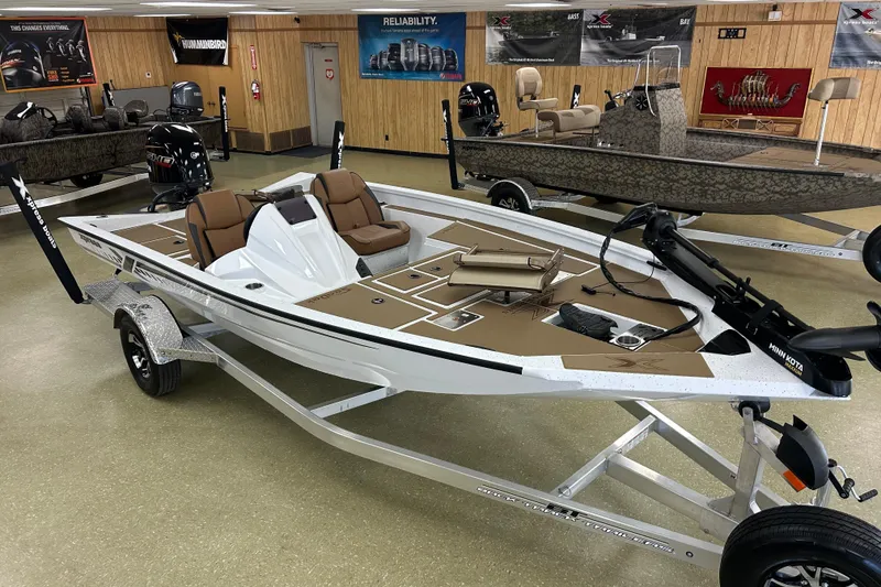 Slide: The Image of 2026 Xpress H18C Crappie boat in showroom, featuring sleek design and modern equipment. - 0