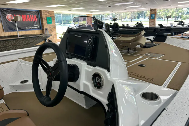 Slide: The Image of 2026 Xpress H18C Crappie boat interior with steering wheel and navigation system. - 3