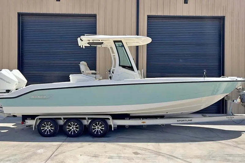 The Image of 2023 Boston Whaler 280 Vantage boat on trailer, parked in front of garage doors. - 1