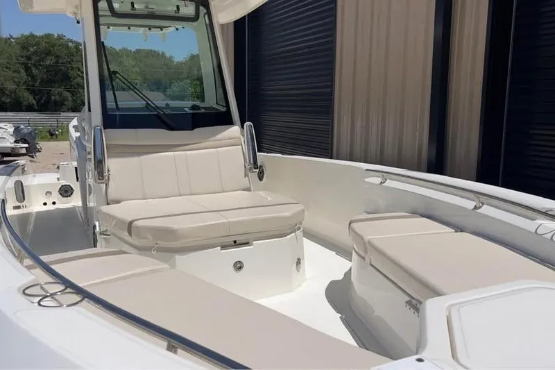 Slide: The Image of 2023 Boston Whaler 280 Vantage boat interior with beige seating and sleek design. - 11