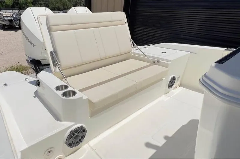 Slide: The Image of 2023 Boston Whaler 280 Vantage boat interior with cushioned seating and cup holders. - 14