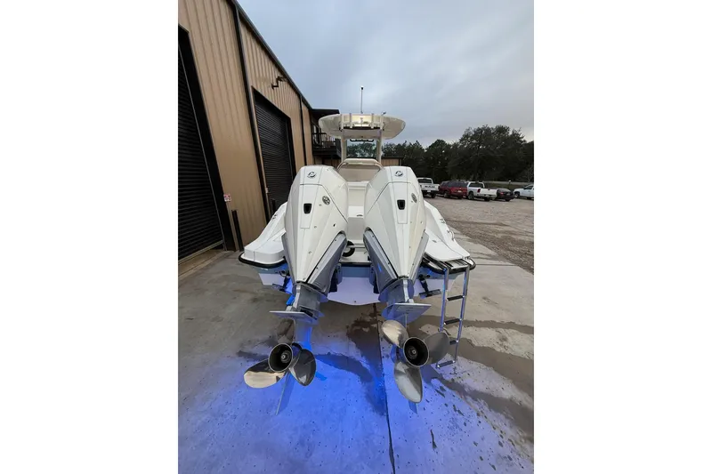 Slide: The Image of 2023 Boston Whaler 280 Dauntless boat with dual engines and blue underwater lights. - 21