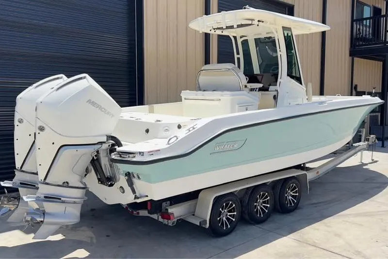 Slide: The Image of 2023 Boston Whaler 280 Vantage boat on trailer, featuring dual Mercury engines. - 3