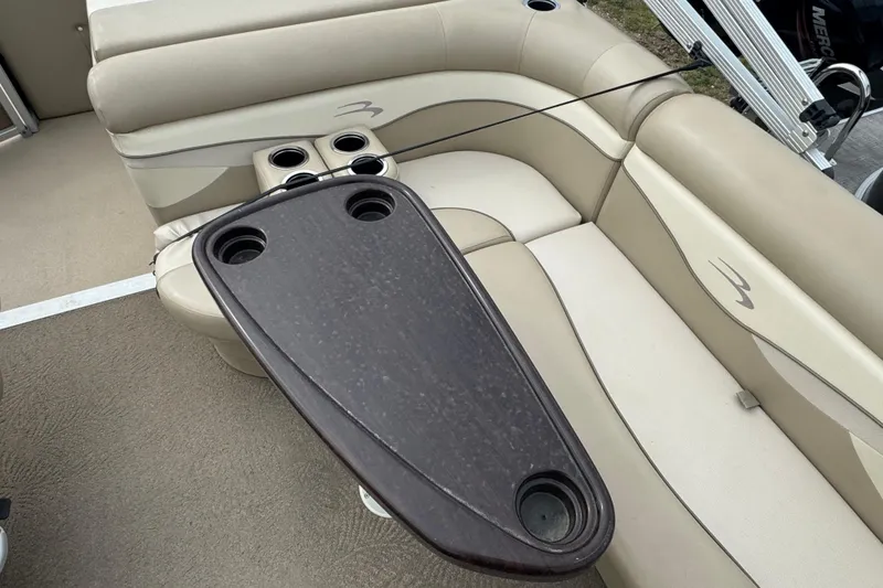 Slide: The Image of 2012 Bennington 24 SF boat interior with steering wheel and seating area. - 10