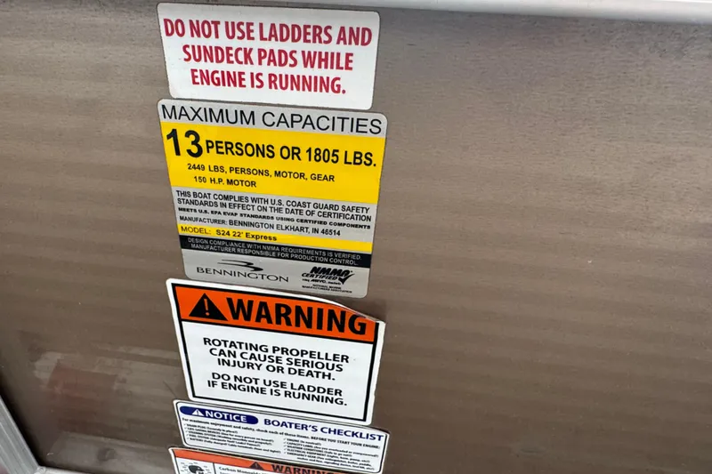 Slide: The Image of 2012 Bennington 24 SF boat deck with ladder and storage compartment. - 16