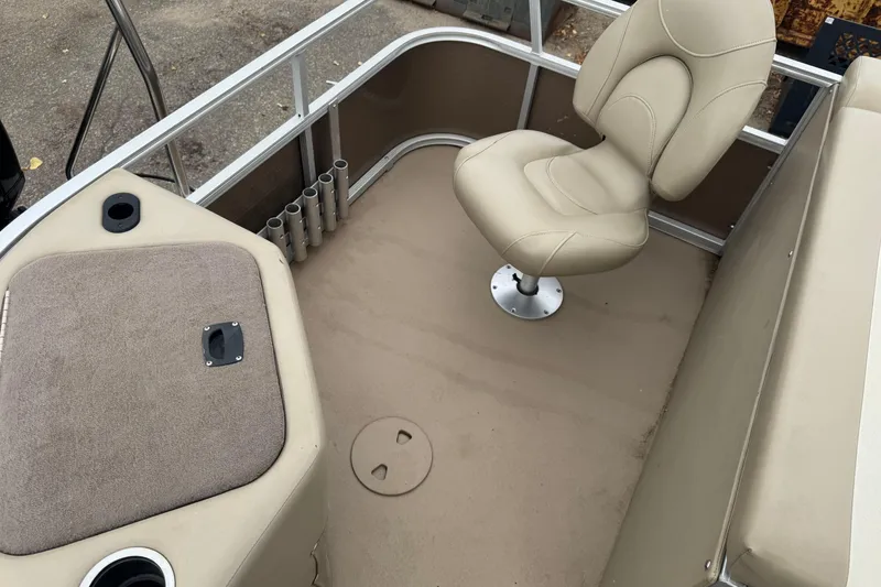 Slide: The Image of 2012 Bennington 24 SF boat interior with beige seating and rod holders. - 17