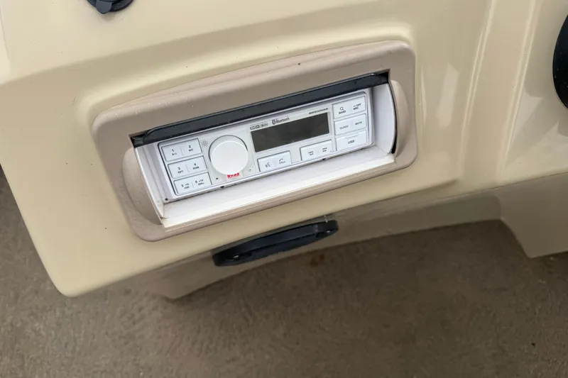 Slide: The Image of 2012 Bennington 24 SF boat dashboard with built-in stereo system. - 23